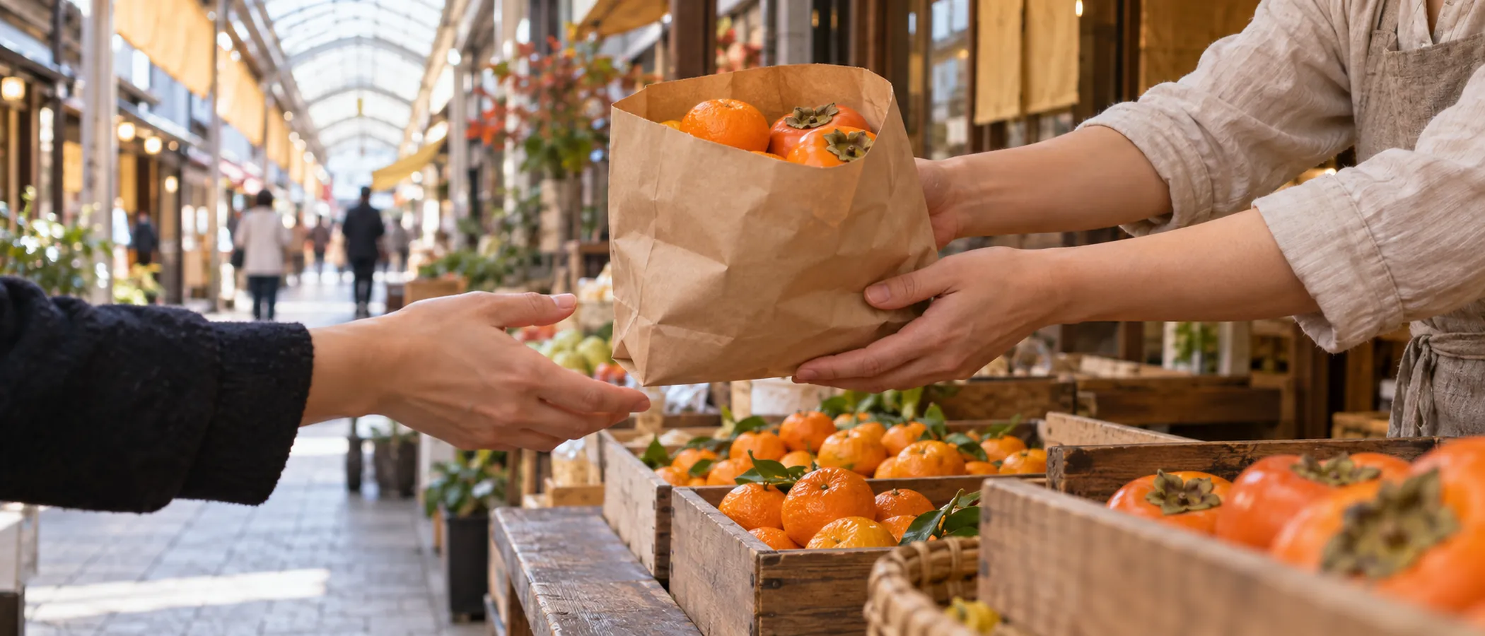 昼下がりのアーケード商店街で、店先から買い物客へ紙袋に入った果物が手渡される場面を手元だけで写したAI生成画像